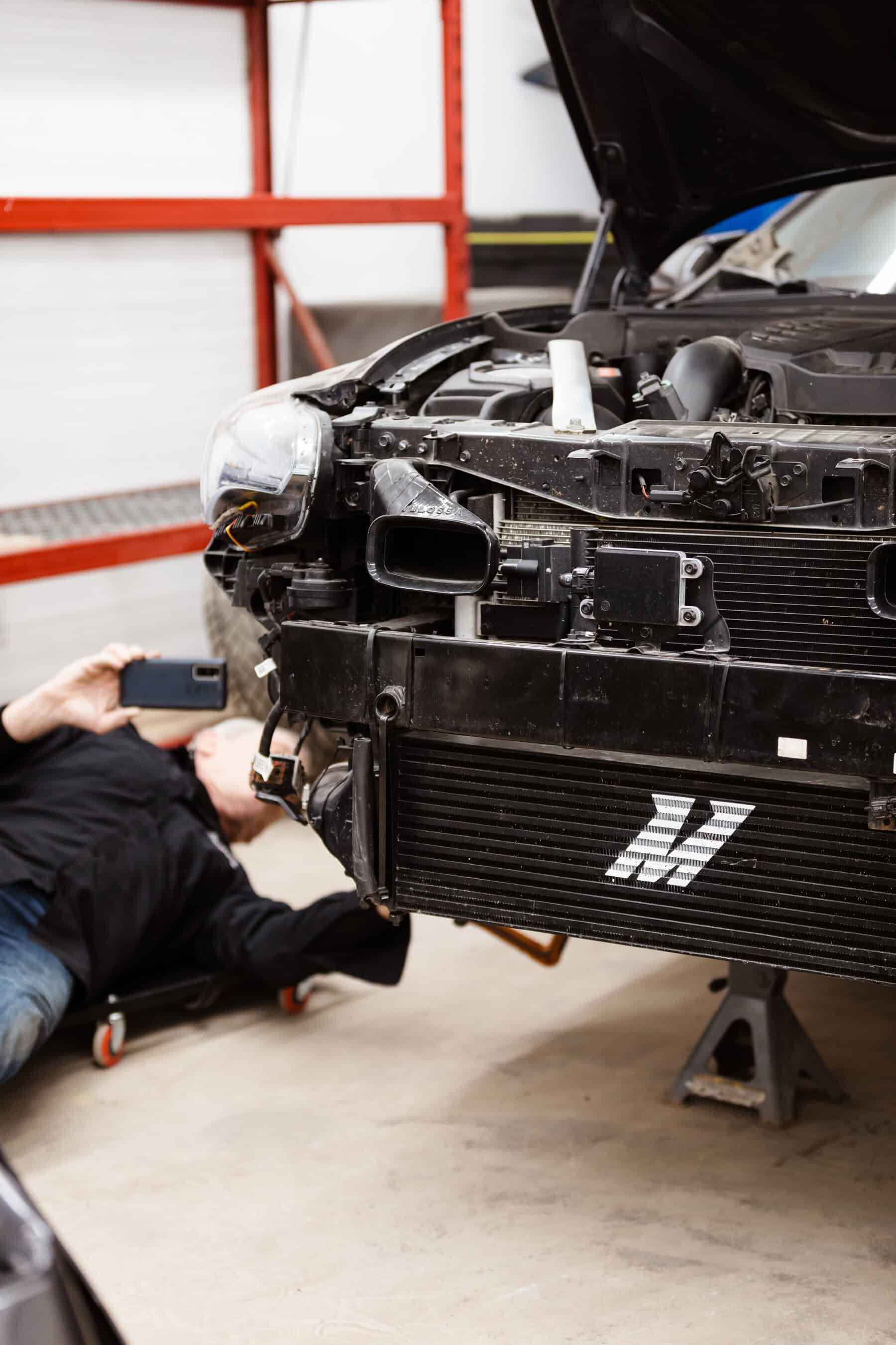 A man working on a car in a garage.
