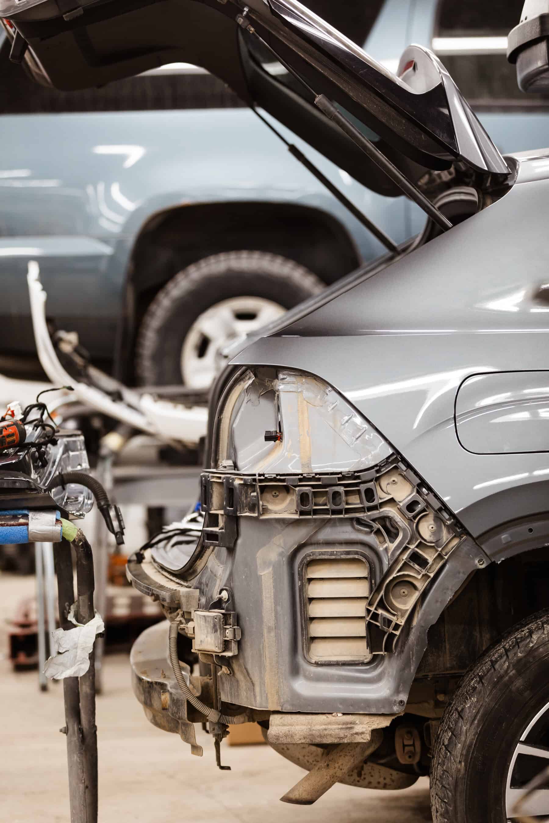 A car that is being worked on in a garage.