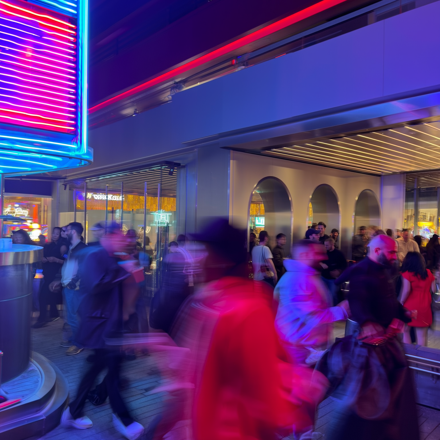 Guests arriving at a glowing venue entrance during an event