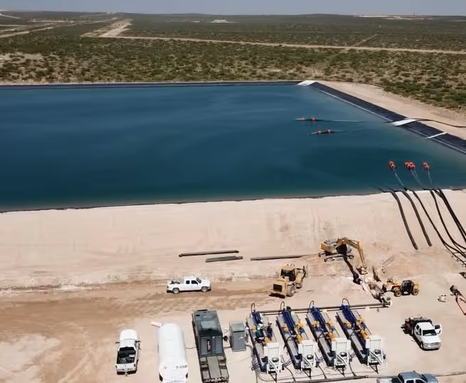 Industrial water reservoir with construction equipment and machinery nearby