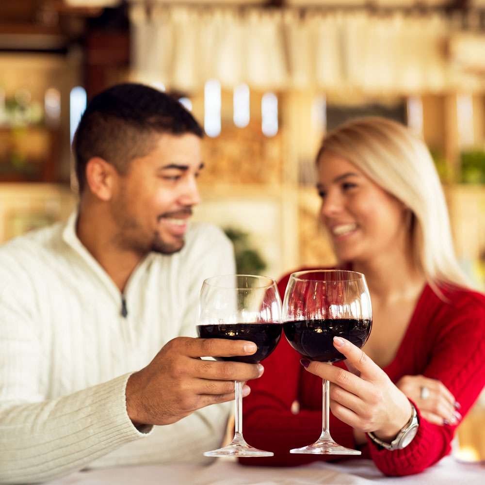A man and woman holding wine glasses.