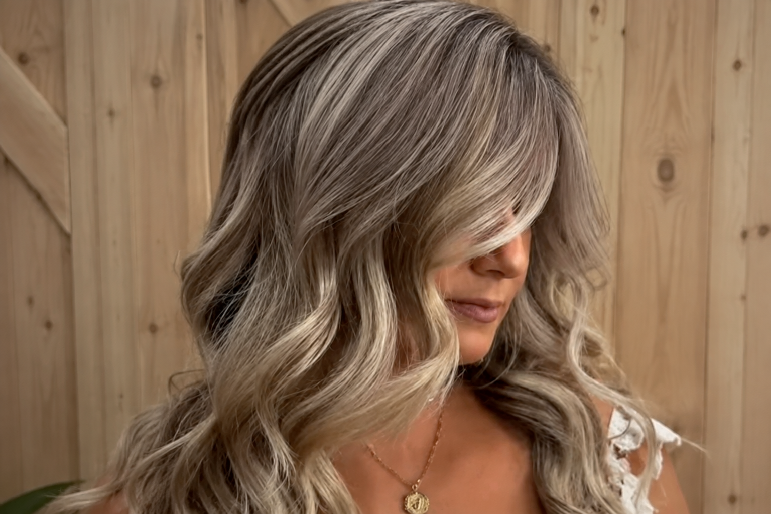 Long dimensional ash-blonde waves styled at Razberri’s Hair, Nail & Spa in Toms River, NJ.