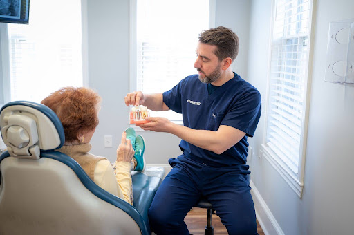 Dentist discussing missing tooth replacement and cosmetic dentistry options with a patient