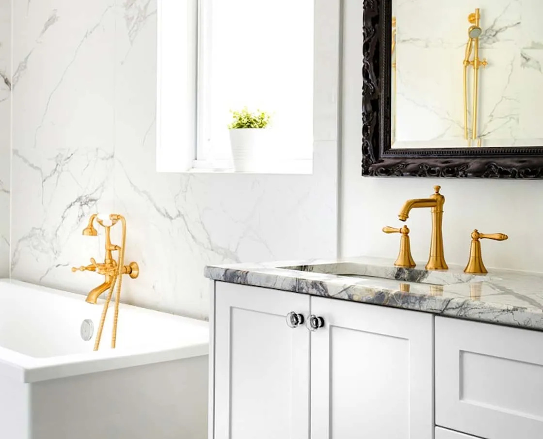 white bathroom with black and gold accents