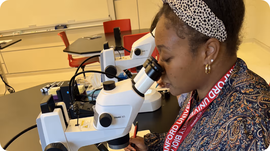 Woman looking into a microscope