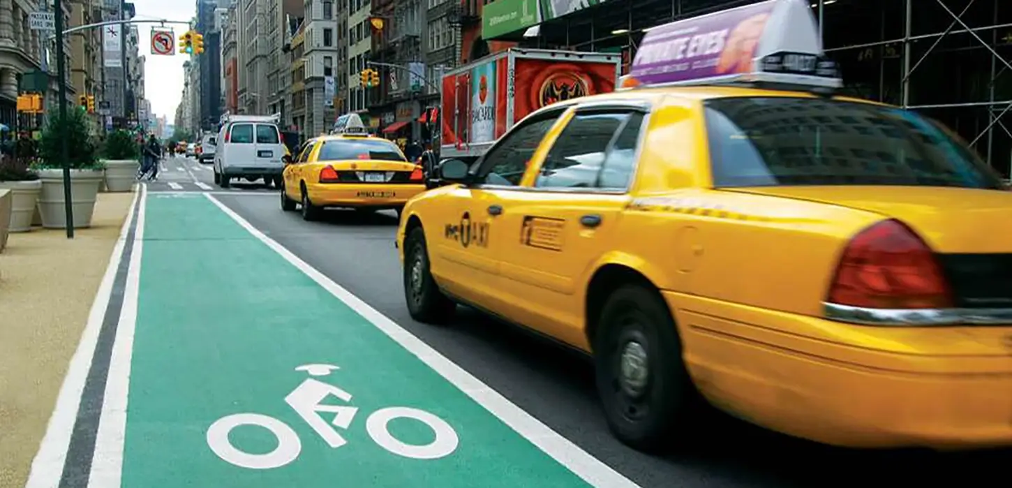 preferential bike lane next to NYC taxi cab in traffic
