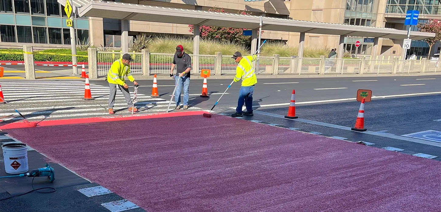 Applicators installing a new crosswalk surface