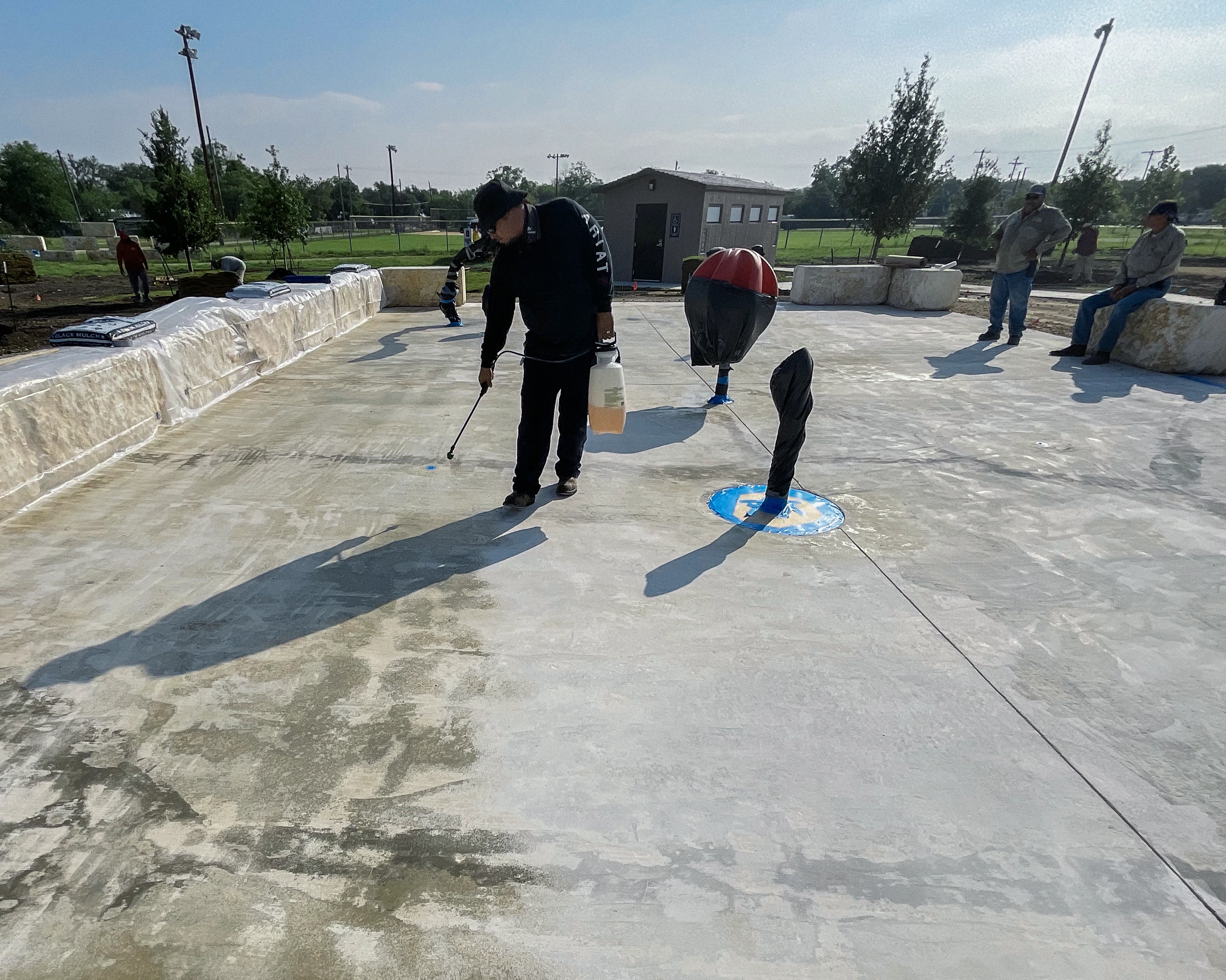 applicators applying concrete primer