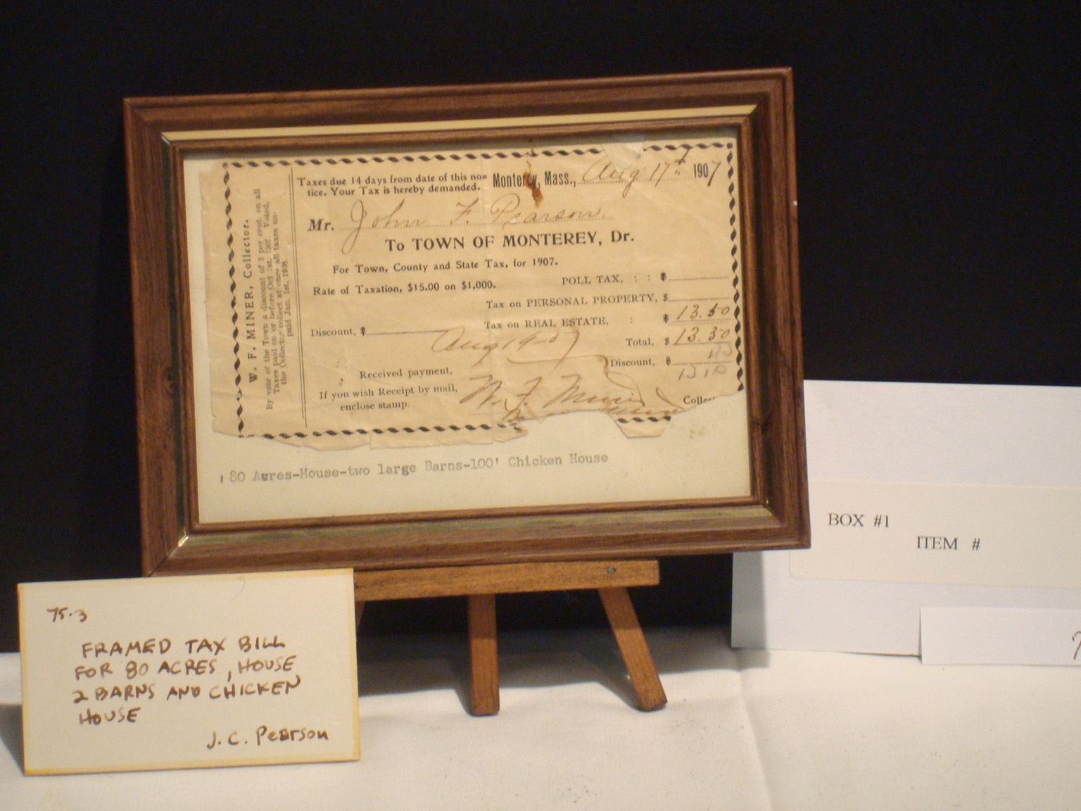 Framed historic tax bill from the Pearson collection, box 1, documenting early financial records in Monterey, Massachusetts.