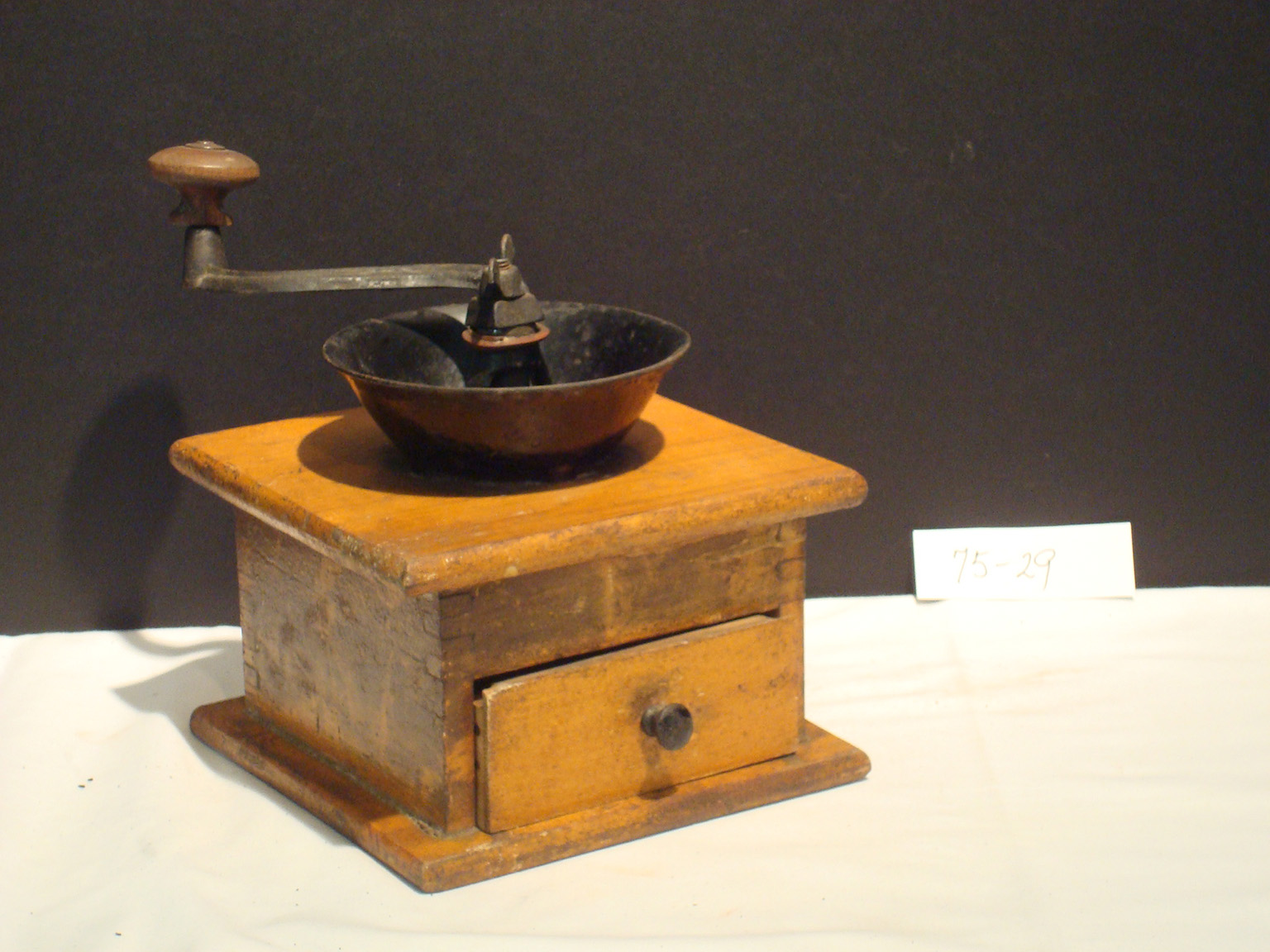 Antique wooden spice mill from Monterey, Massachusetts, used in early domestic kitchens as part of everyday food preparation.