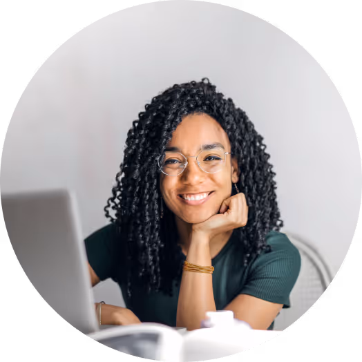 Student smiling while working on computer