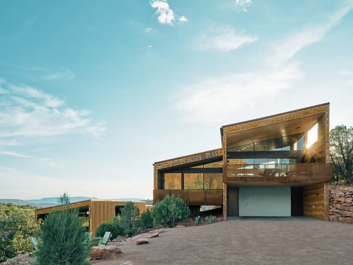 A rusted metal modern home in a beautiful landscape in Sedona