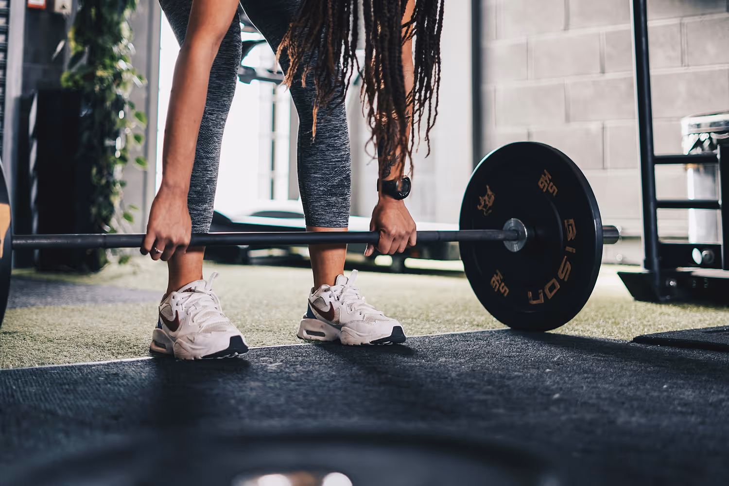 woman deadlifting in gym