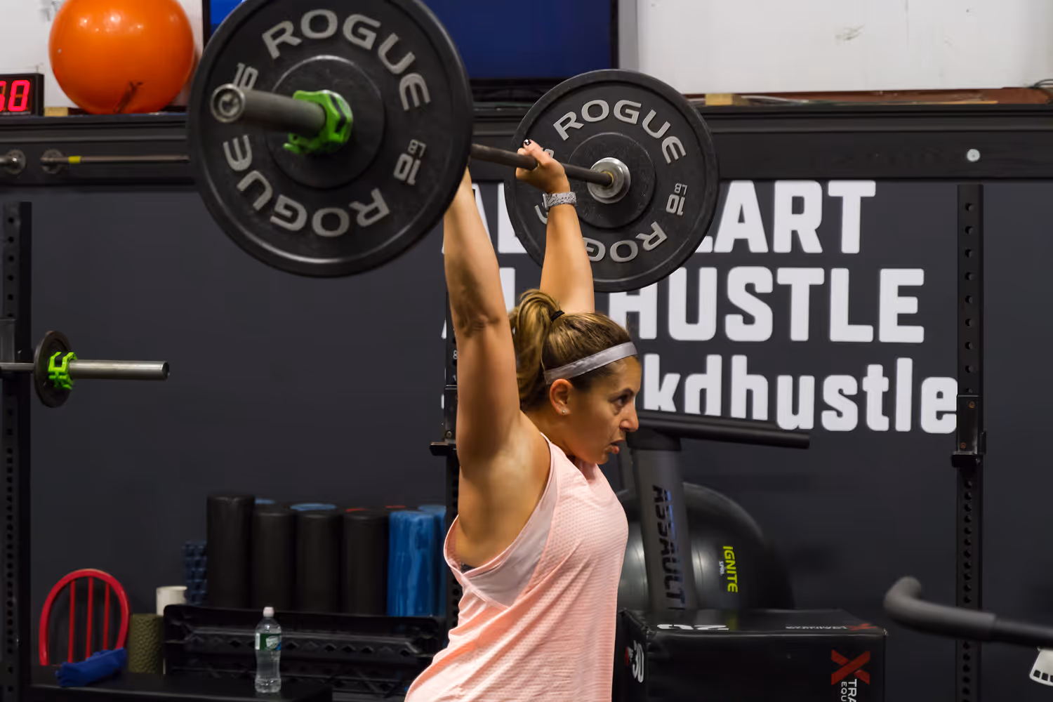 Woman holding weights above her head