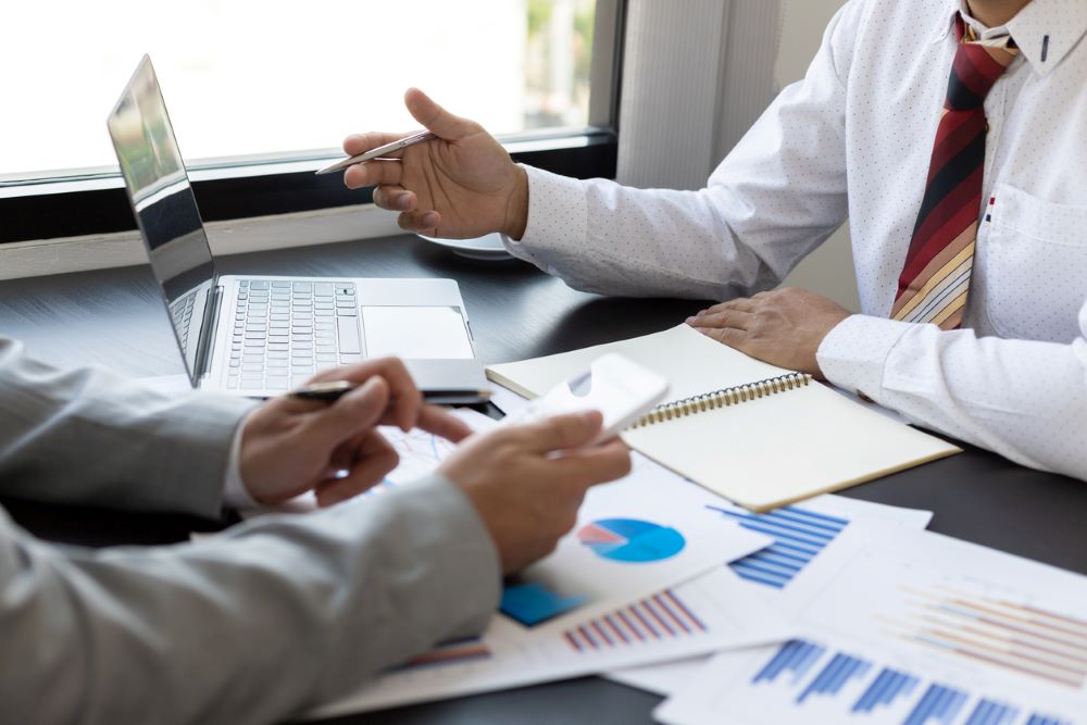 Meeting businessman accounting working on laptop computer and analyzing investment data and auditing.