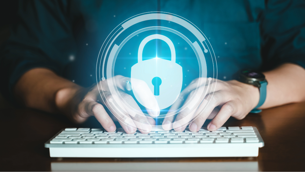 Man typing on a keyboard with a lock symbol above it to represent the warning signs of identity theft