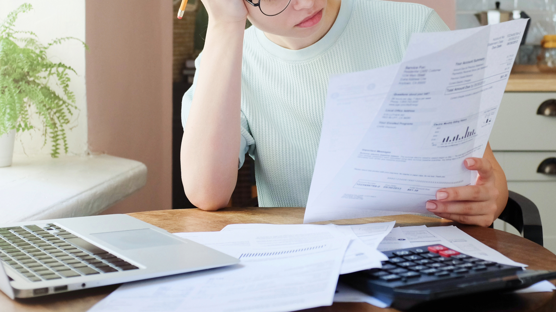 Woman reviewing her credit report and student loan repayment plan, concerned about student loan delinquencies