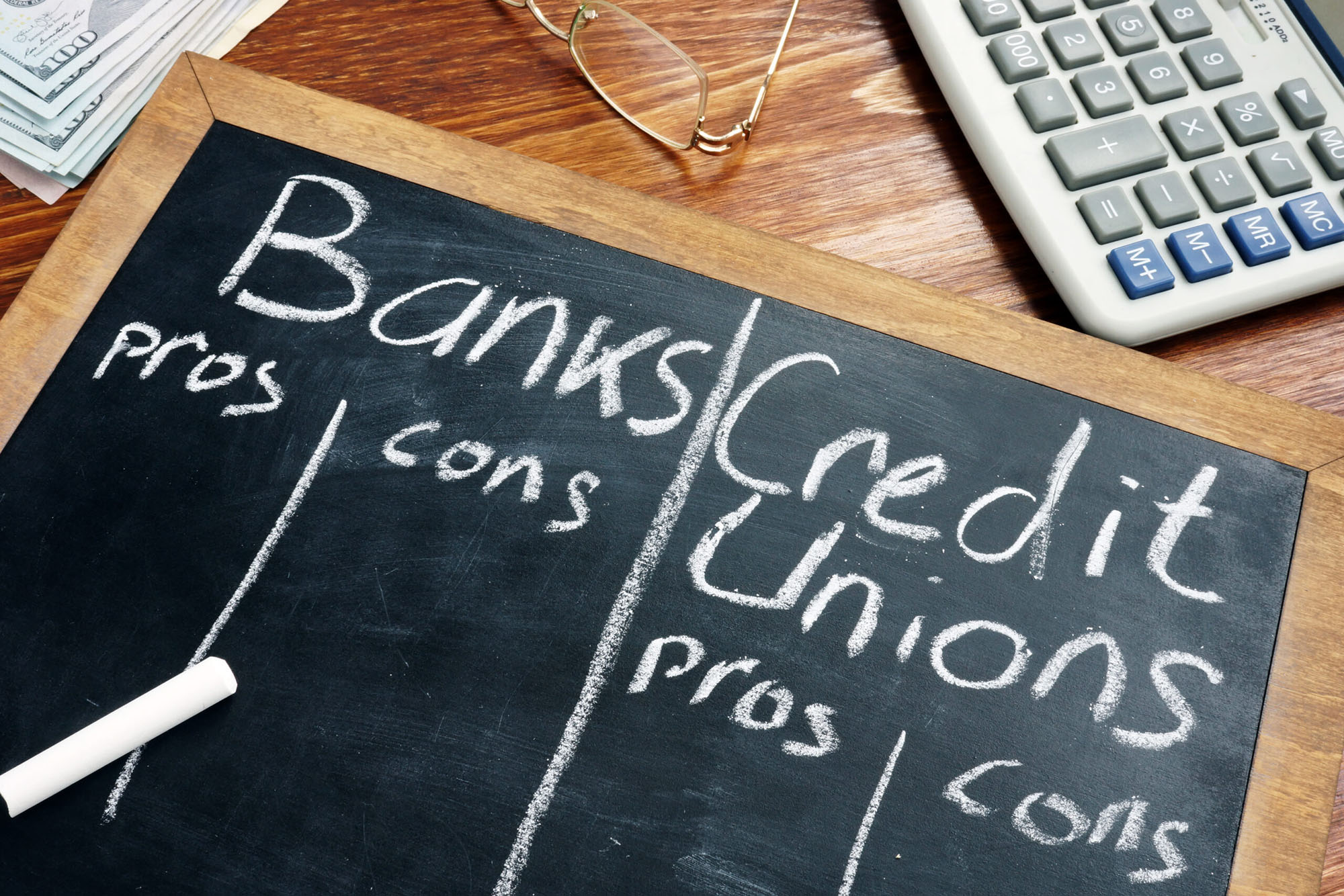 chalk board with the words "banks credit unions"; comparing the pros vs cons