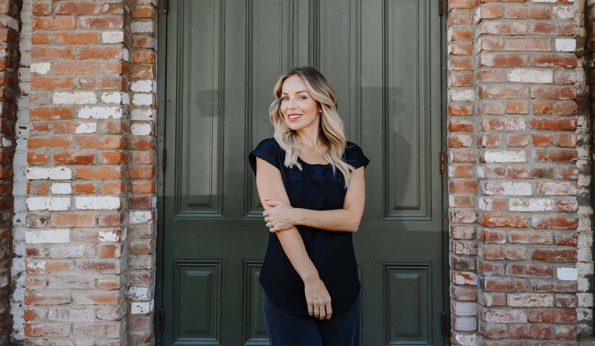 Maribel Campos standing in front of green door