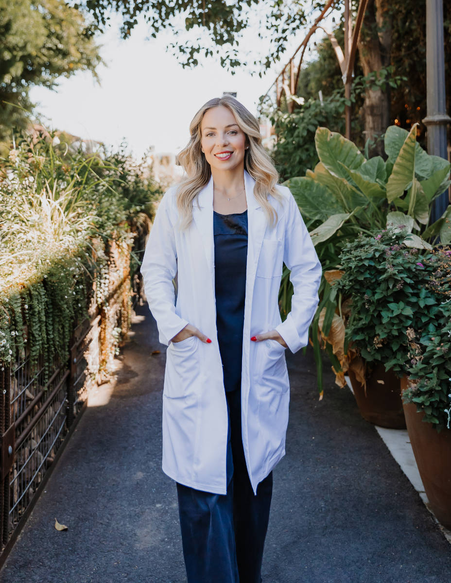 Maribel in physician uniform walking through public space
