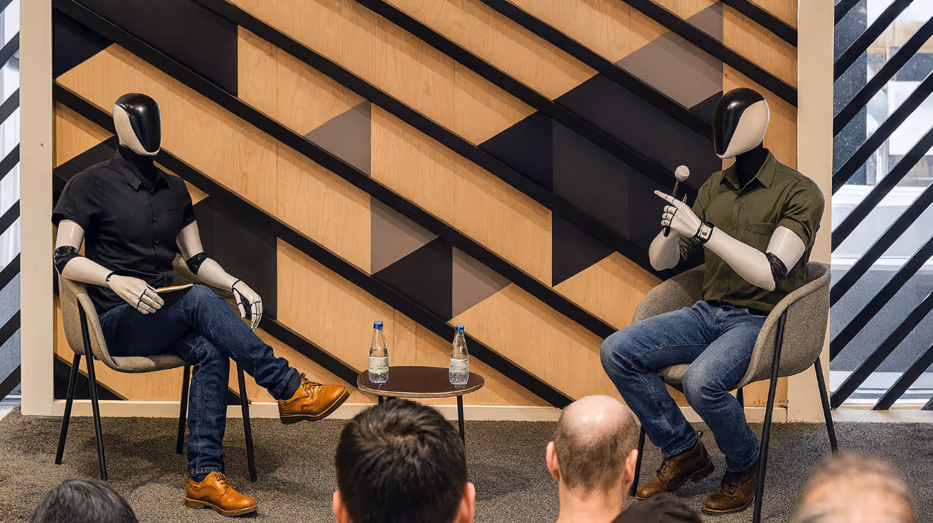 People sitting listening to two people talking