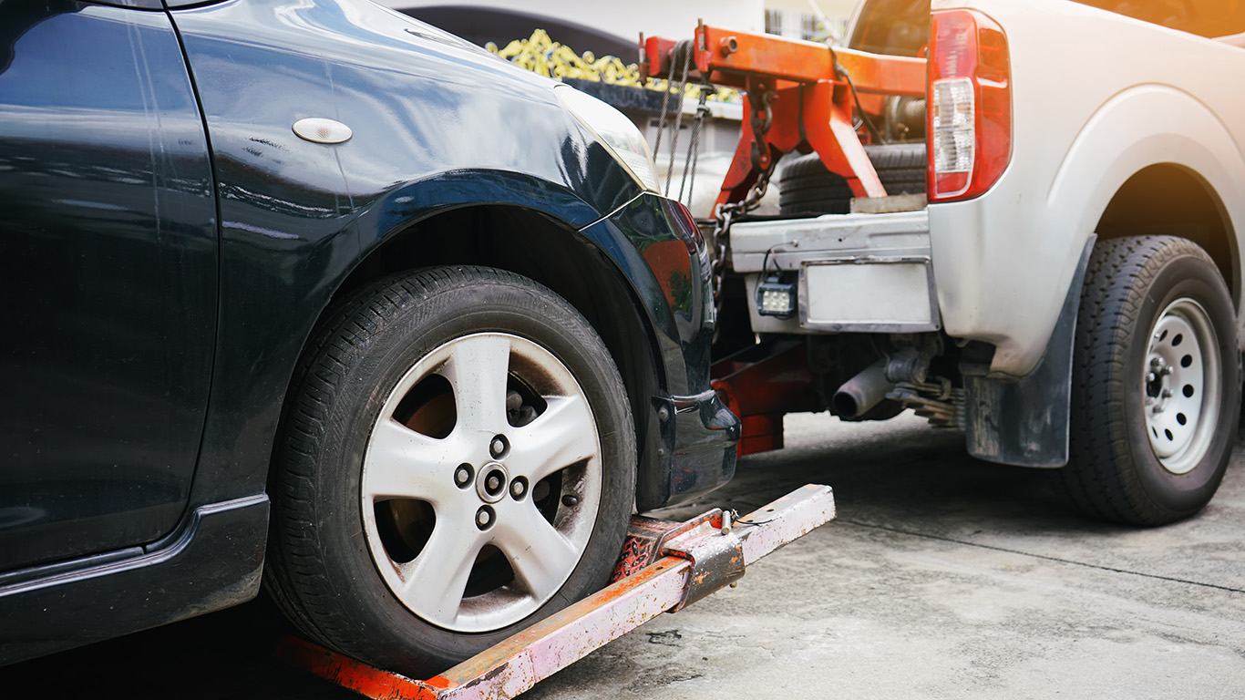 close-up of tow truck securing a car for towing on hook