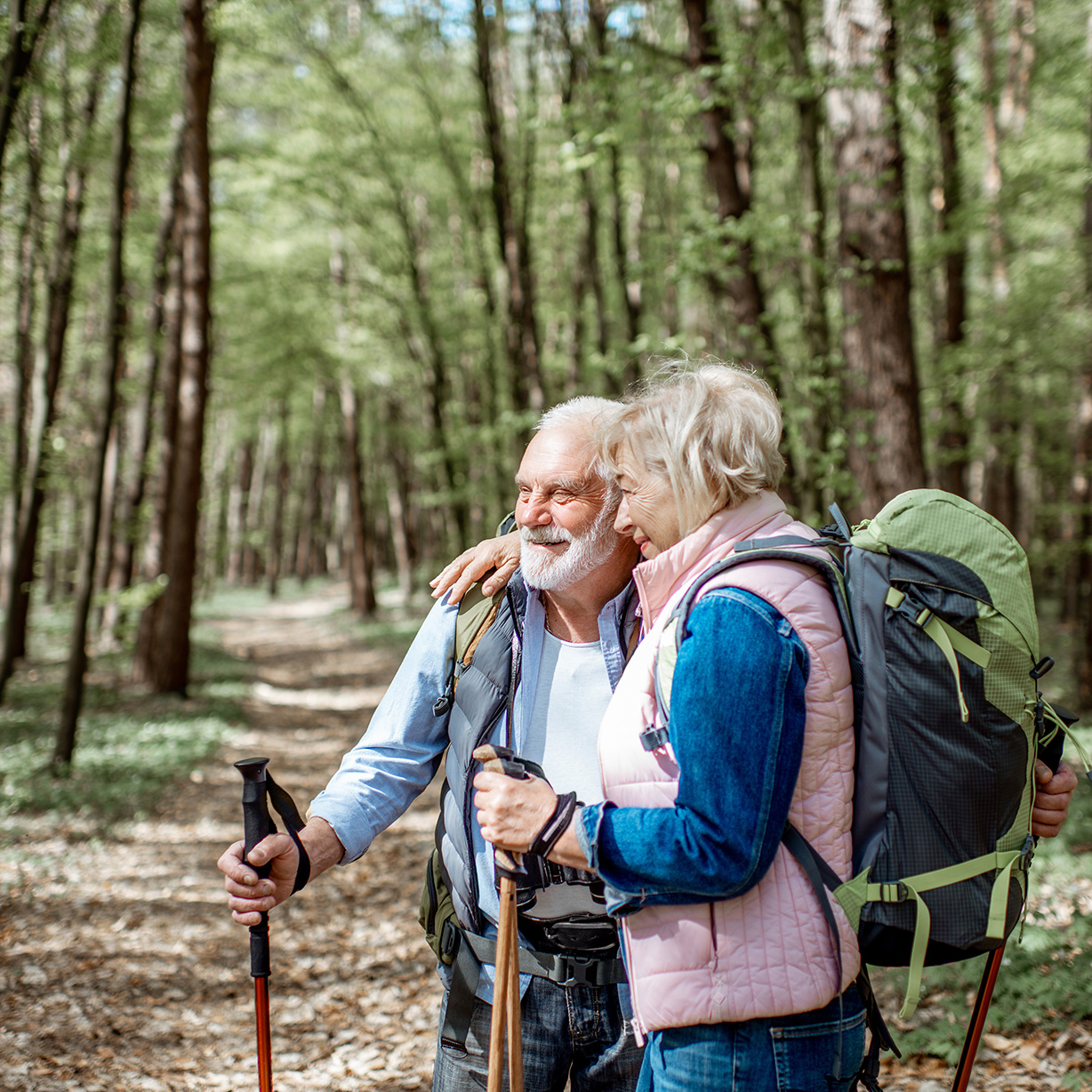 An older couple hiking in the forest