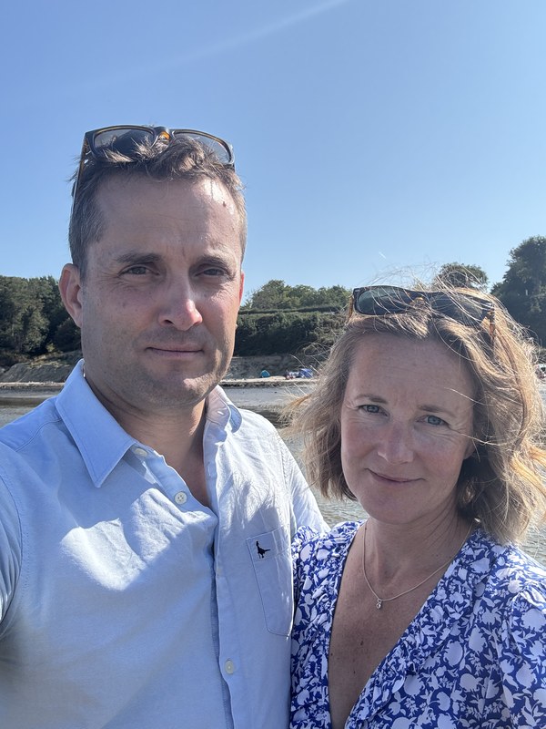 Iain and Tor, hosts of The Sidings, pictured together outdoors by the water.