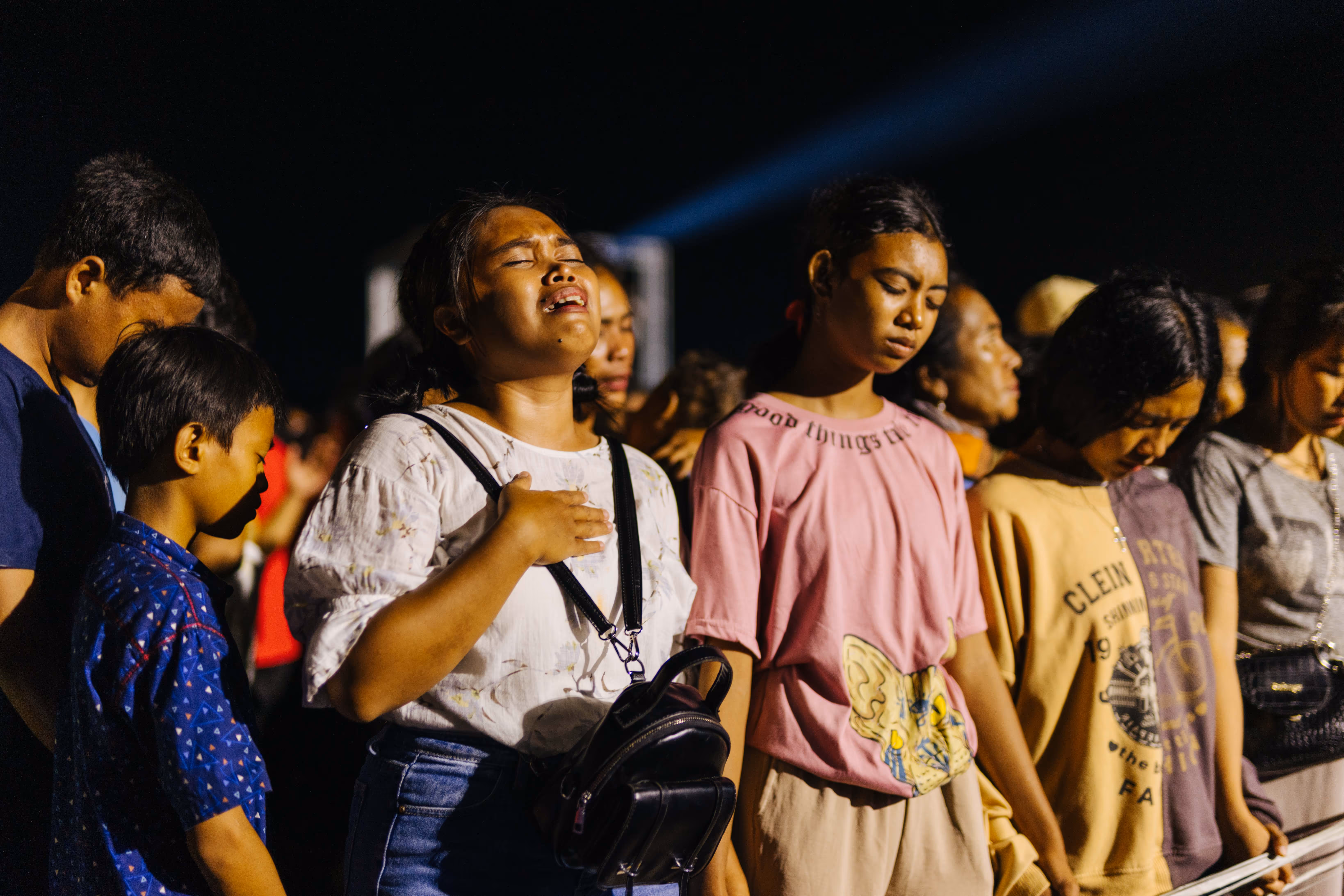 At a gospel festival, amidst a crowd of children and young people, a woman stands overwhelmed by the presence of Jesus. Tears stream down her face as she cries out, deeply moved and touched by heaven.