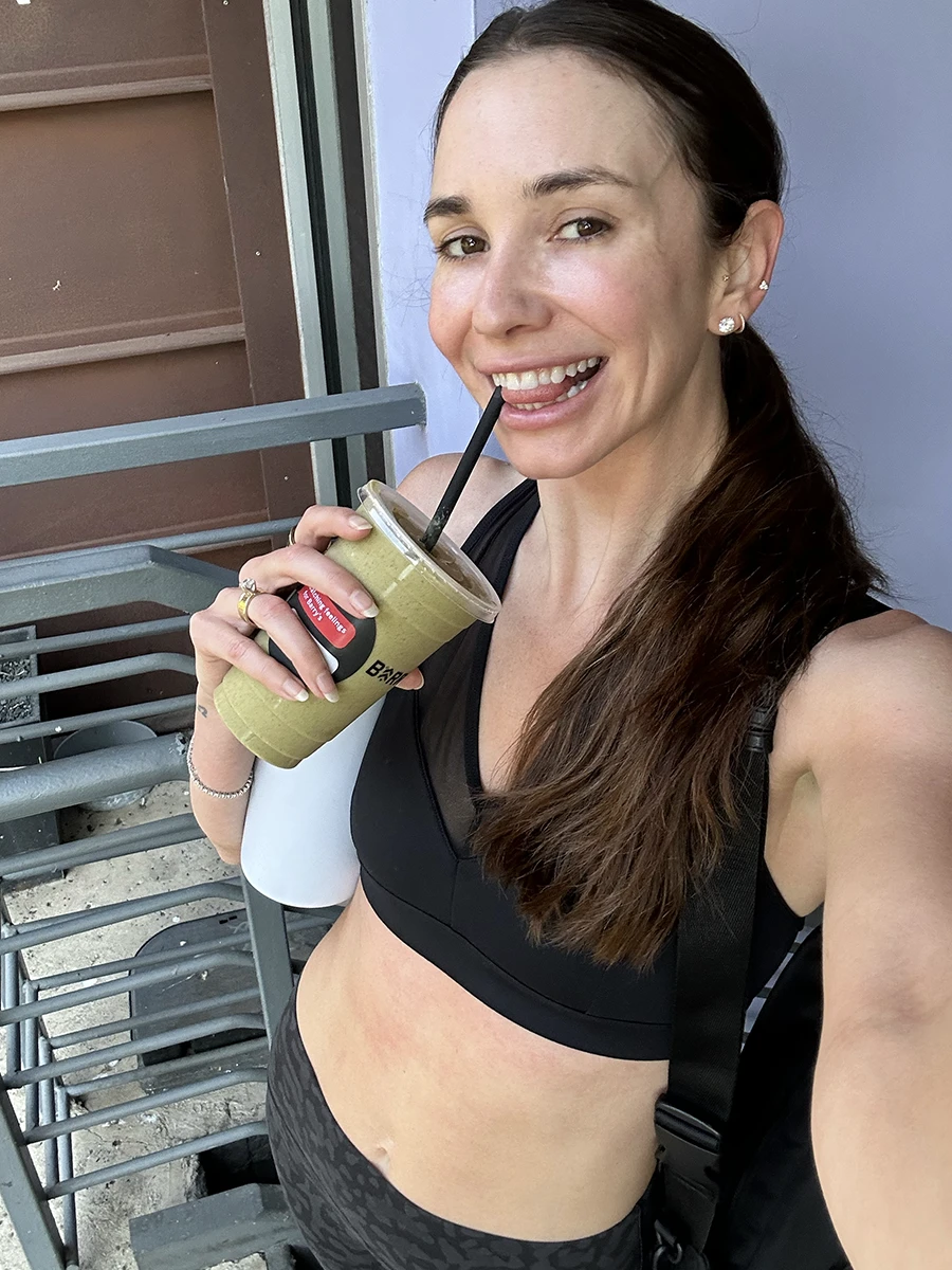 Blaine drinking a smoothie after a workout class