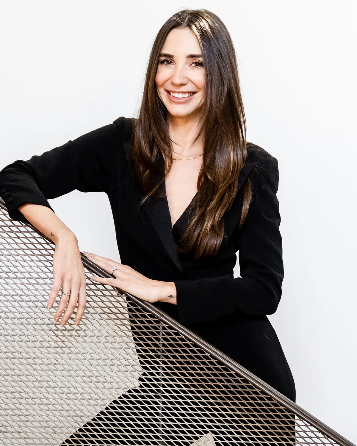 Photo of Blaine in a black jumpsuit, smiling