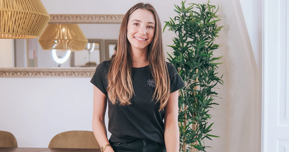 Blaine Anderson in a black tee at home smiling