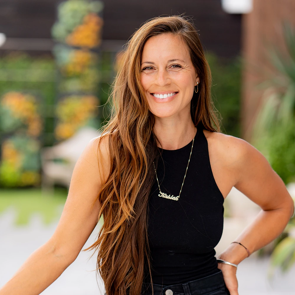 Kahlah, in a black tank top, smiling