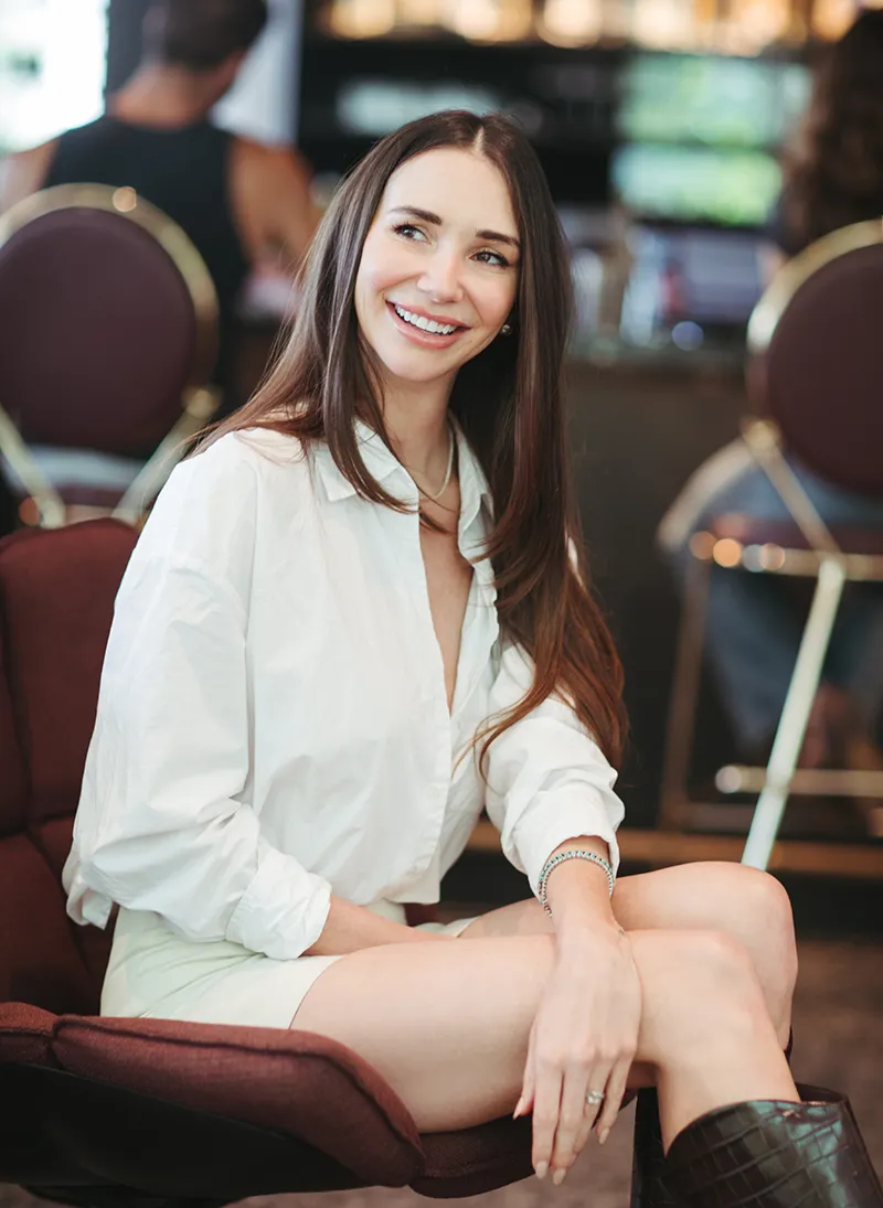 Blaine seated at a bar, smiling