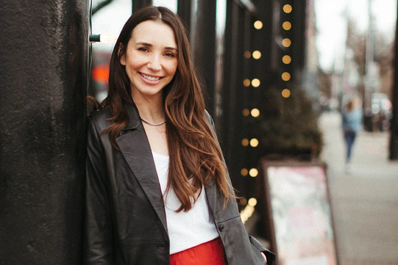 Blaine in a leather jacket, smiling