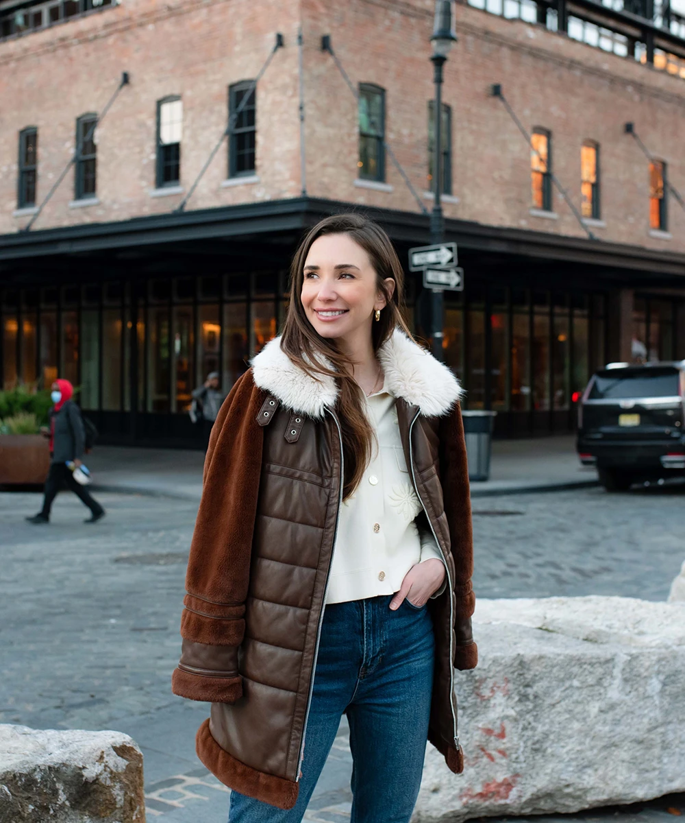 Photo of Blaine in Meatpacking, wearing a brown leather jacket, standing, smiling