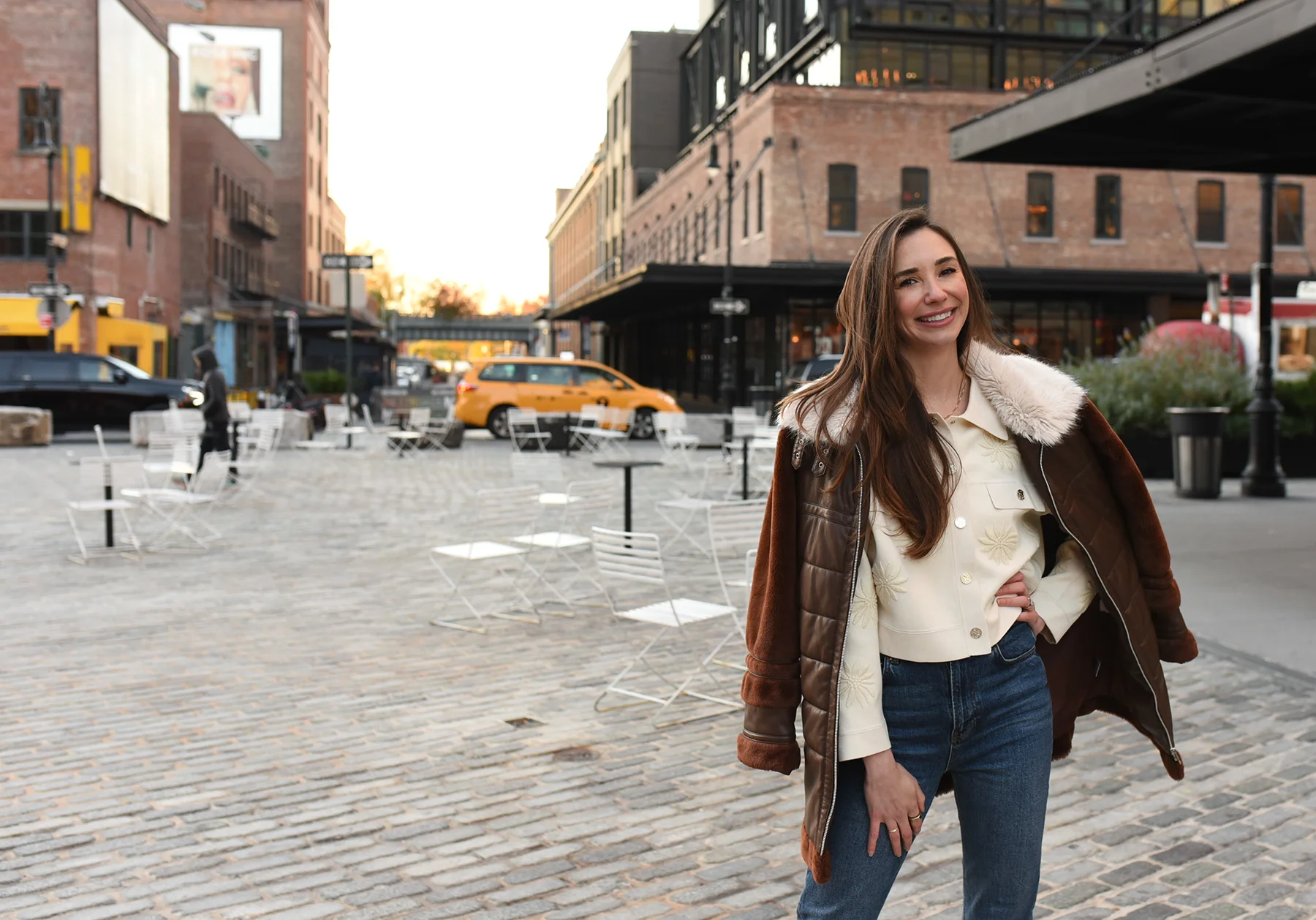 Photo of Blaine in the West Village, with a yellow NYC cab in the background, smiling