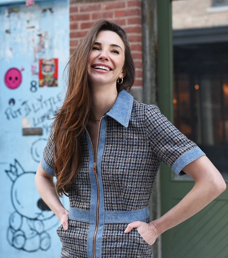 Photo of Blaine in Brooklyn in a blue dress, smiling