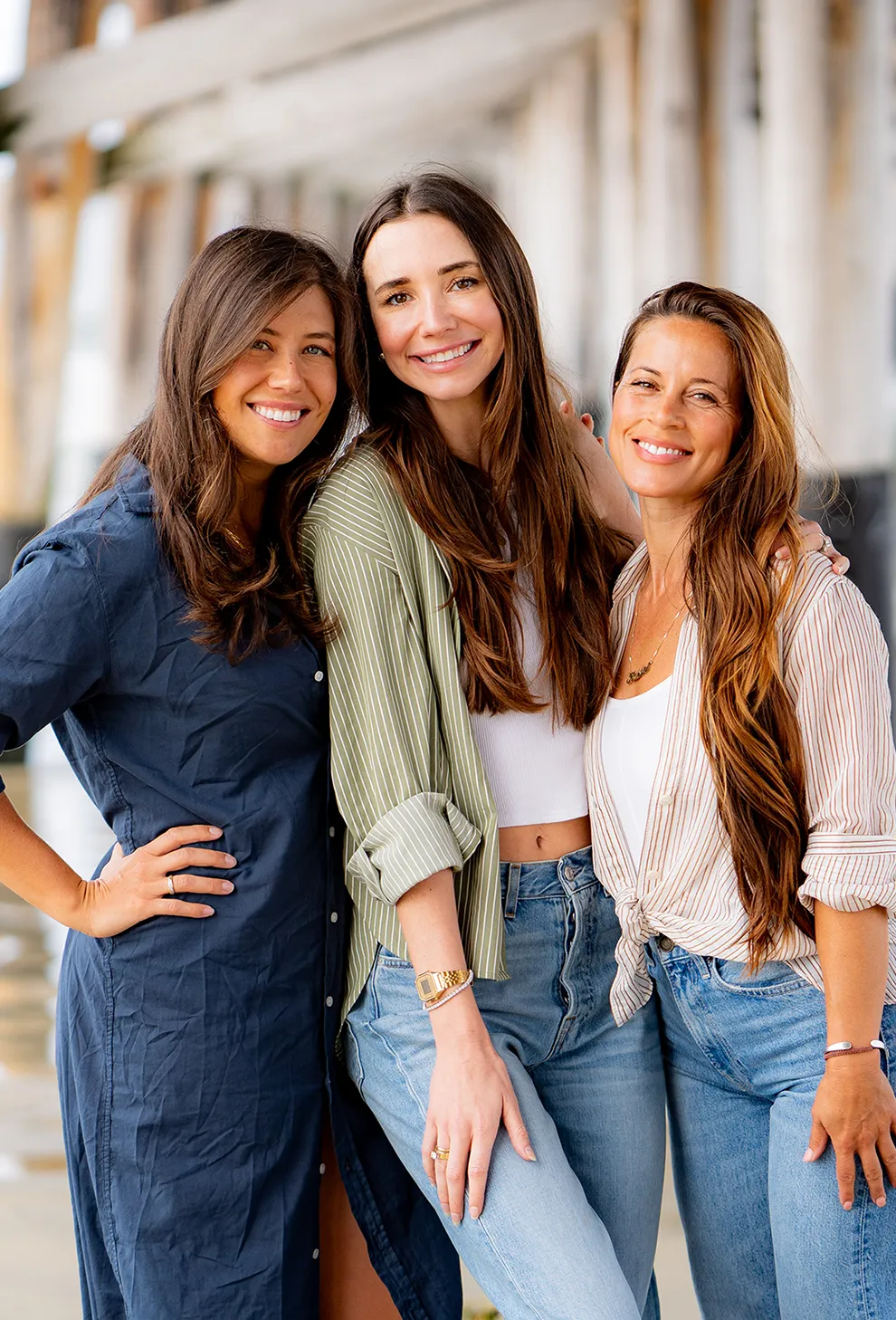 Blaine, smiling, holding a white cup seated at a red café table with croissants.