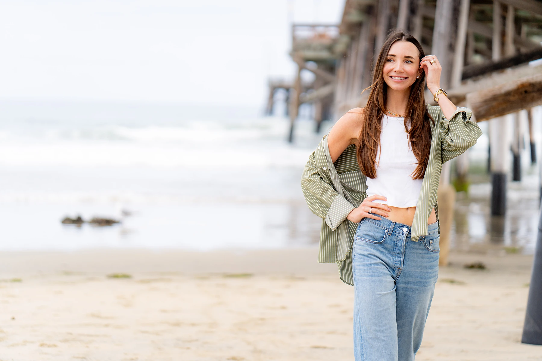 Photo of Blaine walking on the beach in San Diego, smiling
