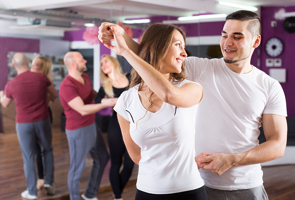 Man and woman dancing in what looks like a dance class studio