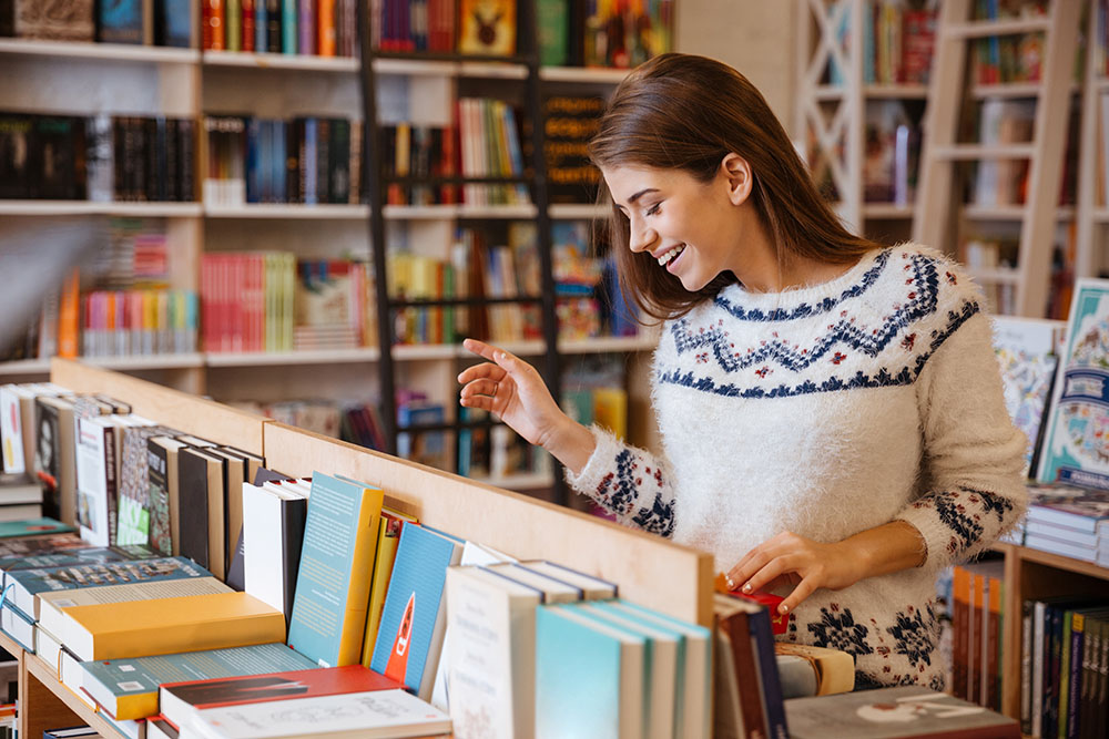 Woman thumbing through titles at a bookstore