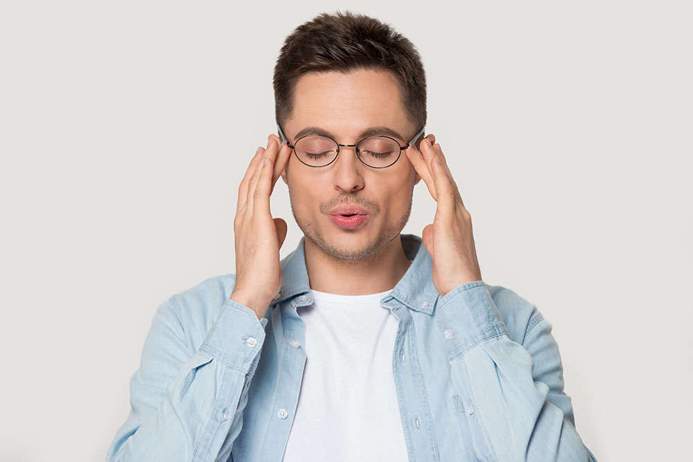 Man touching his temples, deep in thought