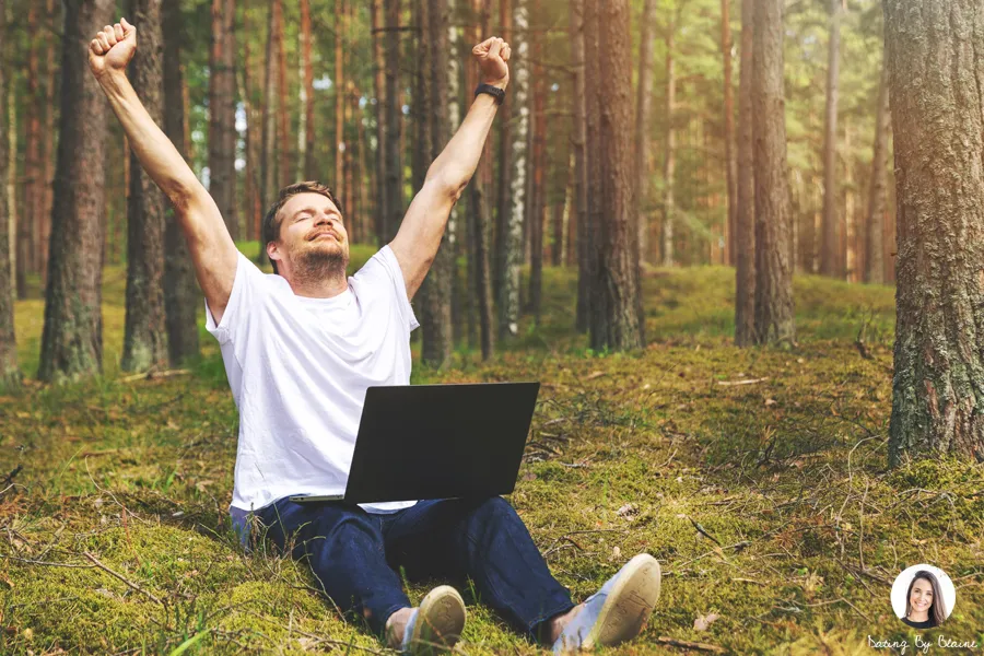 Man stretching his arms up, looking happy