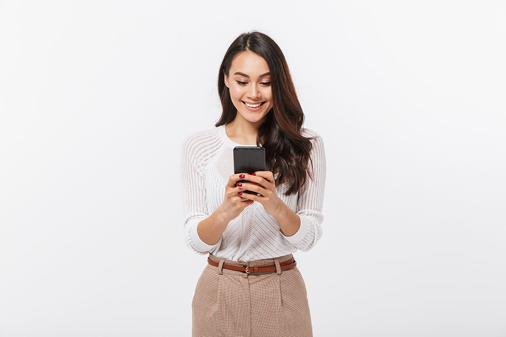 Woman smiling looking at phone