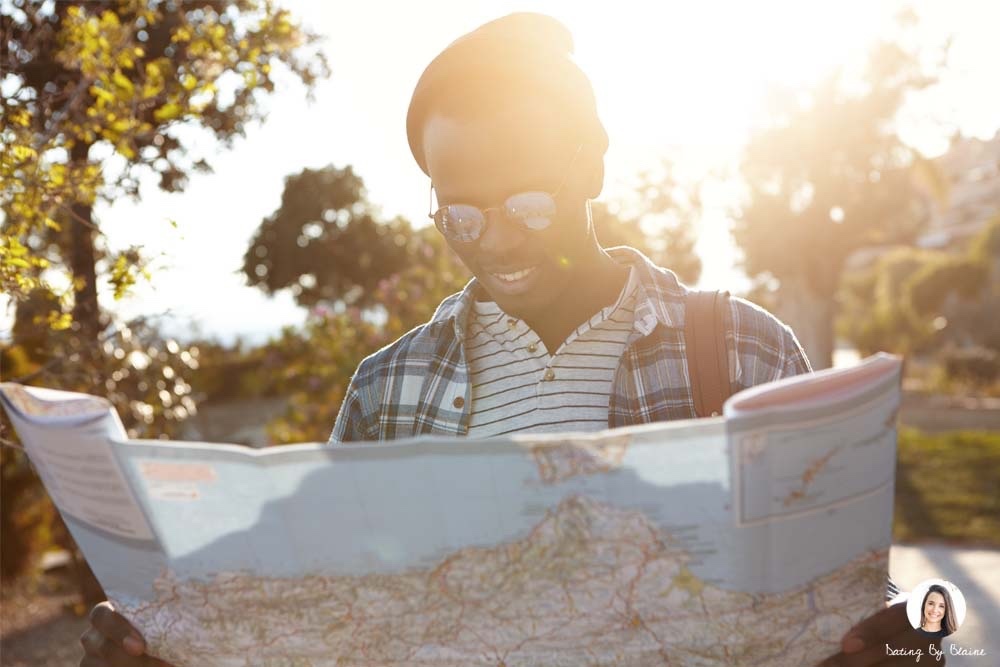 a guy holding a map and smiling