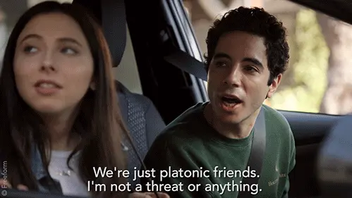 Gif of a guy and a girl seated in a car together, with the guy saying "We're just platonic friends, I'm not a threat or anything"