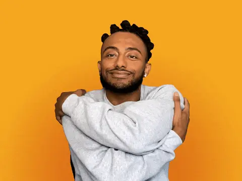 Gif of the rapper Amine hugging himself