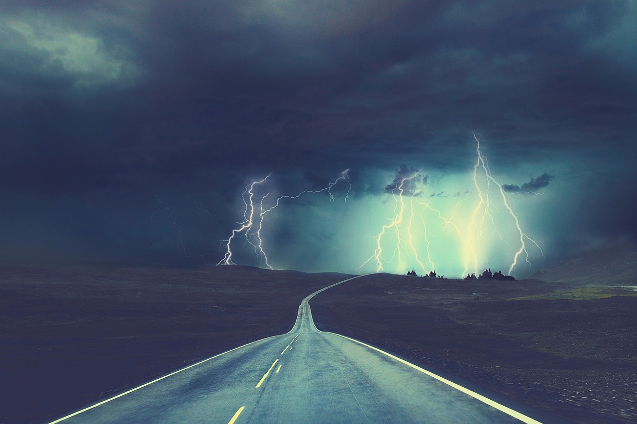 Lightning in distance over a road