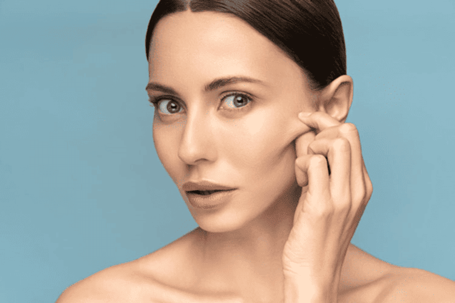 Patient receiving dermal fillers in Los Angeles to enhance facial contours and restore volume.